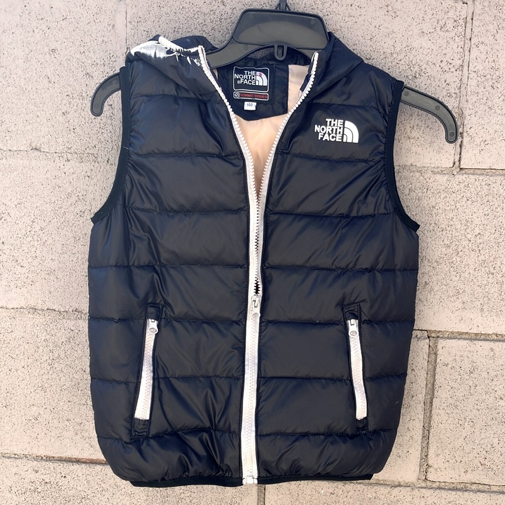 The North Face brand kids vest with pockets.